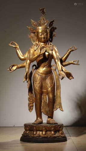 A GILT BRONZE GUANYIN BUDDHA WITH EIGHT ARMS