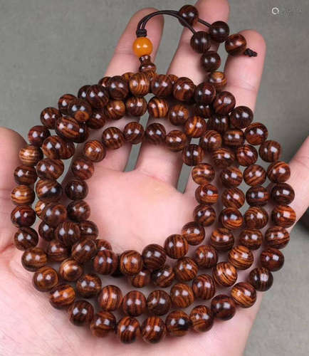 A HUANGHUALI WOOD BRACELET CARVED WITH TIGER PATTERN