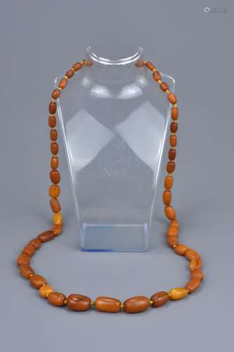 A String of 51 Graduated Amber Beads in Cylindrical forms