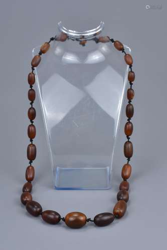 A String of 28 Carved Horn Graduated Beads in a Necklace