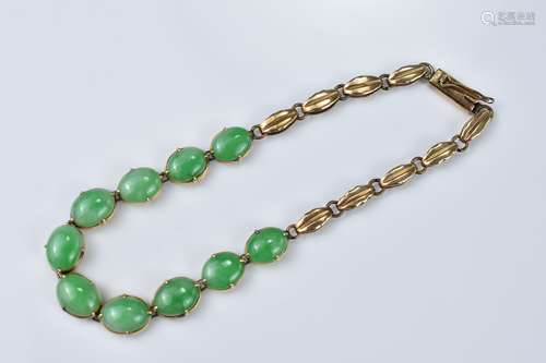 A Yellow Metal Bracelet with Ten Jade Stone Cabochons