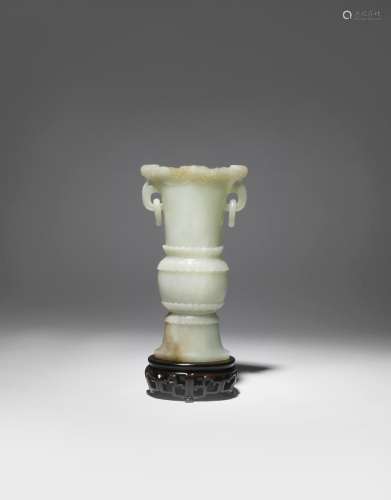 A CHINESE CELADON JADE ARCHAISTIC VASE 18TH/19TH CENTURY Of flattened form, the rim carved in relief