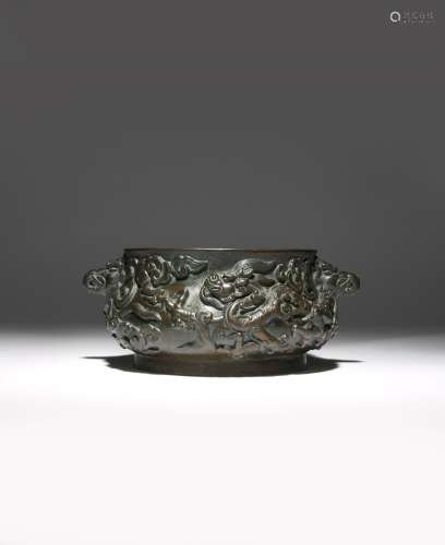 A CHINESE BRONZE 'DRAGON' INCENSE BURNER MING DYNASTY The bombé-shaped body cast in relief with