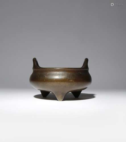 A CHINESE BRONZE TRIPOD INCENSE BURNER 18TH CENTURY The compressed circular body flaring at the rim,