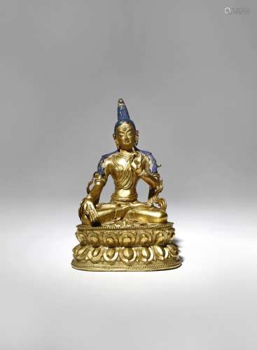A CHINESE GILT-BRONZE FIGURE OF WHITE TARA 18TH CENTURY Cast seated in dhyanasana with one hand held