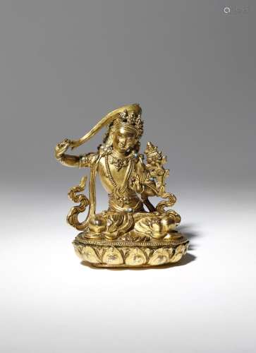 A SMALL CHINESE GILT-BRONZE FIGURE OF MANJUSRI 18TH CENTURY The bodhisattva cast seated in