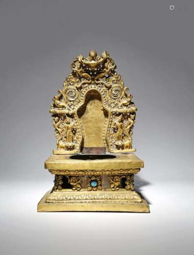 A TIBETAN GILT-COPPER THRONE 18TH/19TH CENTURY With an elaborate repoussι mandorla, decorated with