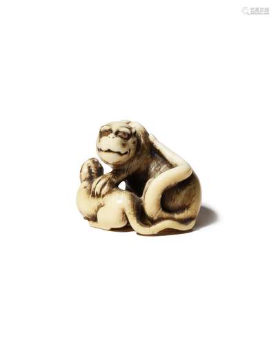 A JAPANESE IVORY NETSUKE OF A TIGER AND HER CUB EDO PERIOD, 18TH CENTURY The feline depicted with