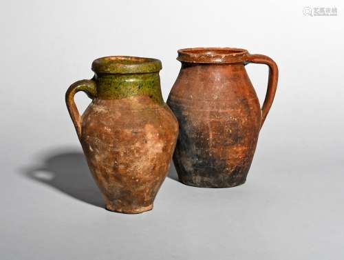 Two English medieval earthenware jugs, c.14th-16th century, one decorated with a mottled Tudor green