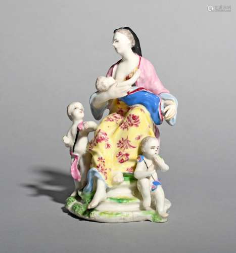 A Bow figure group emblematic of Charity, c.1760, modelled as a mother seated and breast-feeding