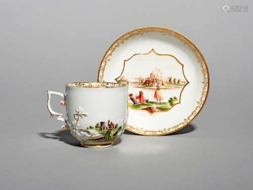 A Meissen Hausmaler cup and saucer, c.1740, applied with three sprigs of flowering prunus and
