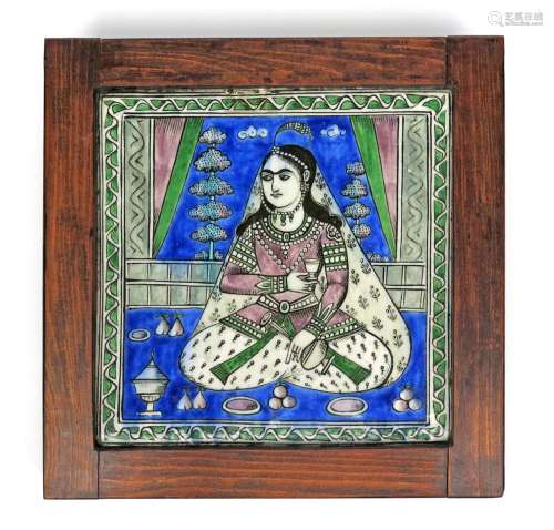 A large Qajar pottery tile, 19th century, the square form painted with a female figure seated