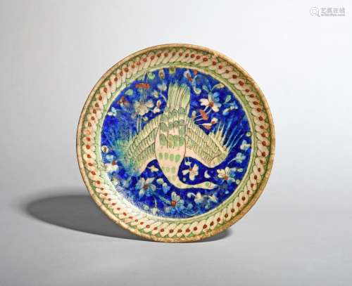 An Islamic pottery dish, 19th century or earlier, painted in the Iznik manner with a central bird
