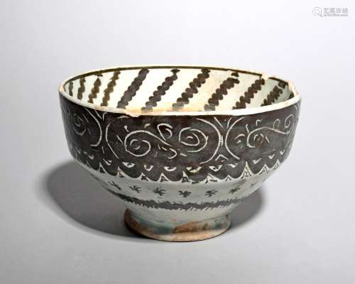 An Islamic pottery bowl, probably 19th century, of ogee form, the sides with sgraffito decoration of