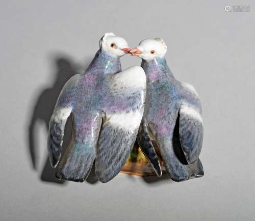 A Meissen group of pigeons, 19th century, the fancy birds billing with one enclosing the other's
