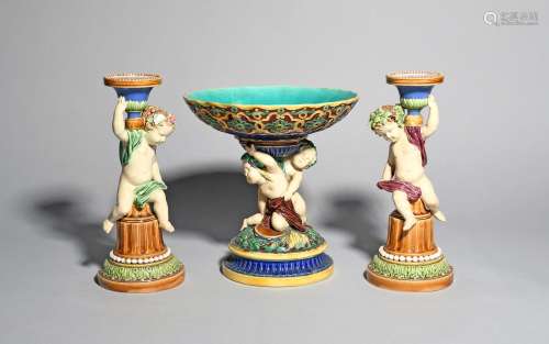 A pair of Minton Majolica figural candlesticks and a tazza, date codes for 1864 and 1844, the