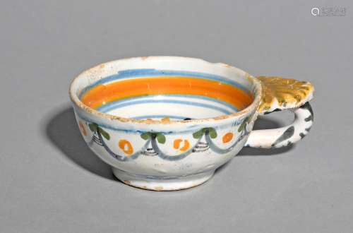 A faïence shallow cup or wine taster, c.1780, the shallow circular bowl decorated to the interior