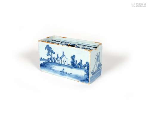 A delftware flower brick, c.1760, the rectangular form painted to the long sides with a figure in