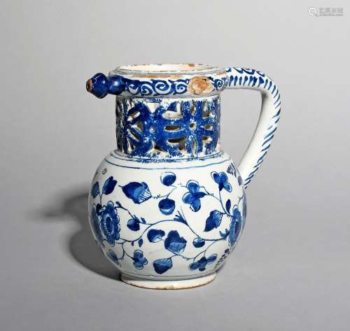 An English delftware puzzle jug, mid 18th century, possibly Bristol, the rounded body painted in