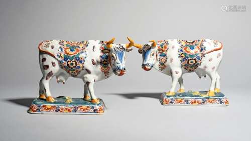 A pair of Delft figures of cows, 19th century, each standing four square on a rectangular base