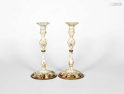 A large pair of Staffordshire enamel candlesticks, c.1770, the lobed bases painted with scenes of