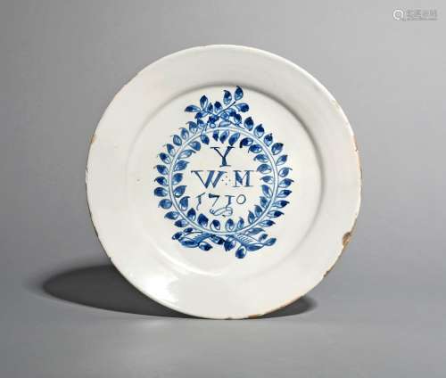 An English delftware plate, dated 1710, inscribed in blue with the letter Y over the initials W M