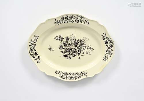 A large creamware charger, late 18th century, printed in black with a moth in flight beside a
