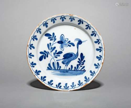 A delftware plate, mid 18th century, probably Bristol, painted in blue with a standing crane or