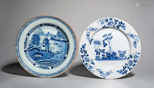 Two delftware chargers, c.1740-60, one painted with flowering peony and stems of bamboo, with flower