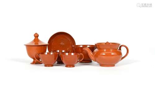 A glazed redware miniature part tea service, early 19th century, the lightly turned pieces decorated