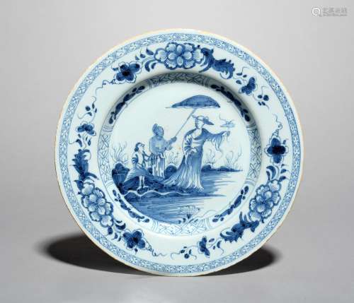 A delftware 'Dame au Parasol' plate, mid 18th century, painted in blue with a design after Cornelius