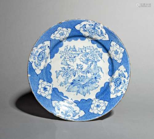 A Liverpool delftware plate, c.1760, painted in blue with a kylin seated on a square cushion