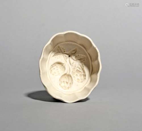 A salt-glazed stoneware butter mould, mid 18th century, the inside impressed with a spray of