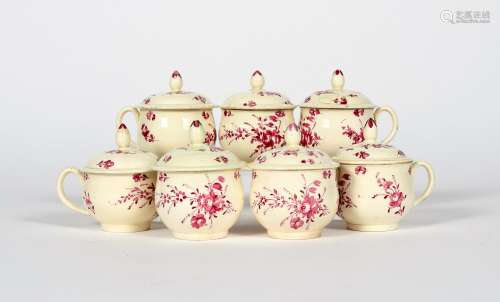 Seven creamware custard cups and covers, c.1770-80, the rounded forms decorated in puce camaieu with