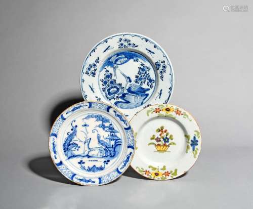 Two Delft plates and a small delftware plate, 18th century, one painted with a standing crane