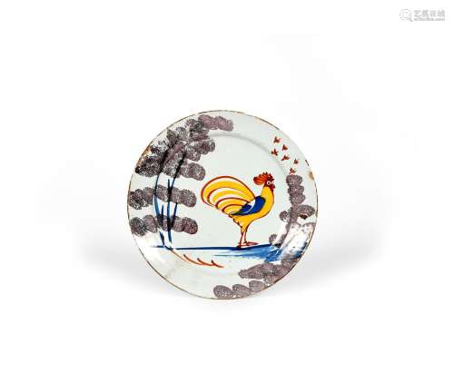 A Bristol delftware 'Farmhouse' plate, c.1720-30, painted with a bold cockerel in yellow, blue and
