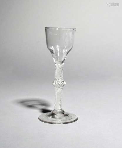A wine glass, c.1760, with an ogee bowl raised on an opaque twist stem with central knop above a