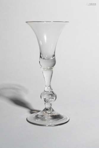 A baluster wine glass, c.1740, with a bell bowl raised on a baluster stem with a large knop