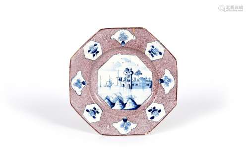 A Wincanton delftware octagonal plate, c.1740, the well painted in blue with a soldier guarding a