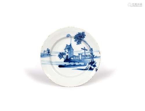A delftware plate, mid 18th century, probably Bristol, painted in blue with a tall house at the