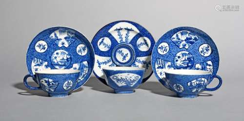A pair of Bow blue and white cups and saucers, c.1760-65, painted with a fan-panelled pattern of