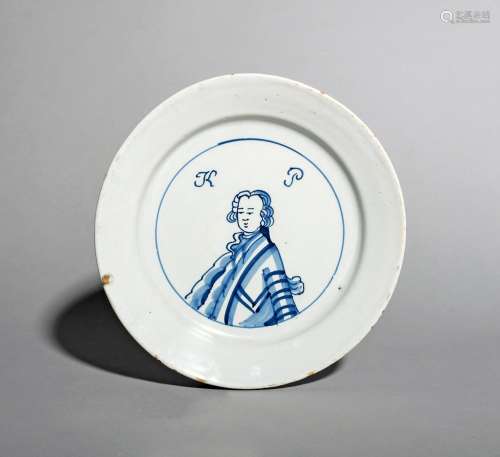 A good and rare English delftware King of Prussia plate, c.1757-60, painted in blue with a head