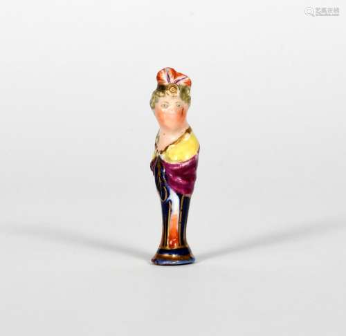 A Derby pipe tamper, .1770, modelled as the head and shoulders of a lady with feathered headdress,