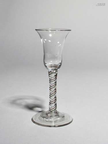 A coloured twist wine glass, c.1760, with a bell bowl raised on a stem enclosing blue, red, green