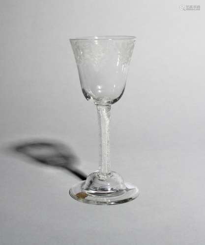 A wine glass, c.1760, with a generous rounded funnel bowl engraved with a continuous band of