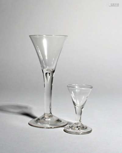 A gin glass and a wine glass, c.1760-70, each with a drawn trumpet bowl above a plain stem, the wine
