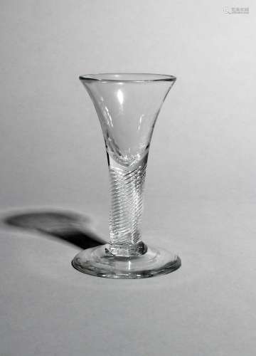 A small wine or dram glass, c.1750-60, with a drawn trumpet bowl rising from a thick airtwist