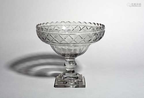 A large Irish cut glass footed bowl, 19th century, of ogee form, cut with a narrow diamond band