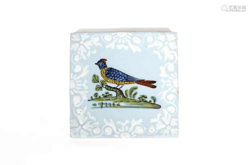 A Bristol delftware bird tile, c.1760, decorated with a bird perched on a stump, painted in red,