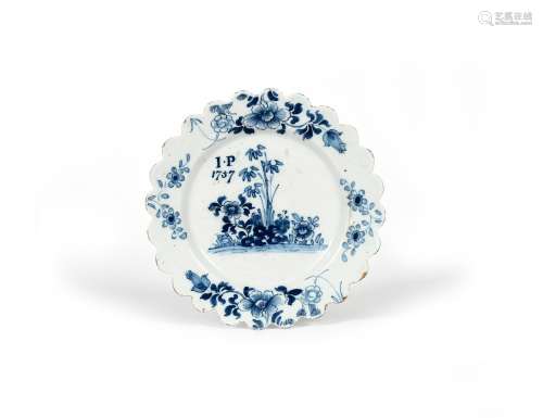 A delftware plate, dated 1757, possibly Liverpool, painted in blue with bamboo and flowering